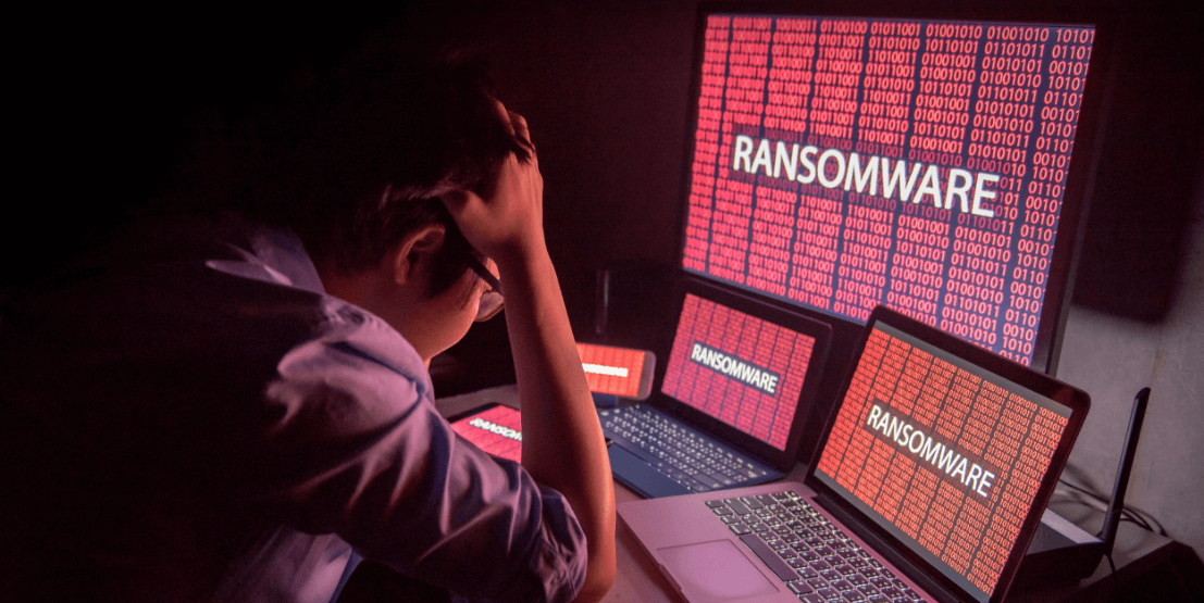ネットワークセキュリティに対してのサイバー攻撃に頭を抱える男性
