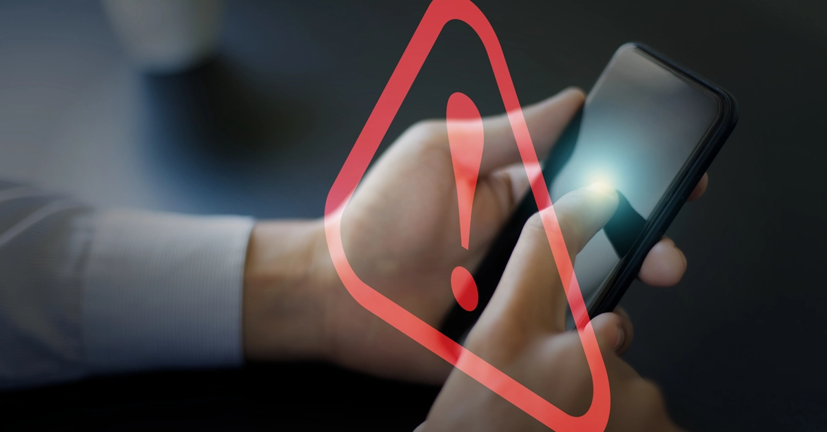 スマホと警告マークの画像